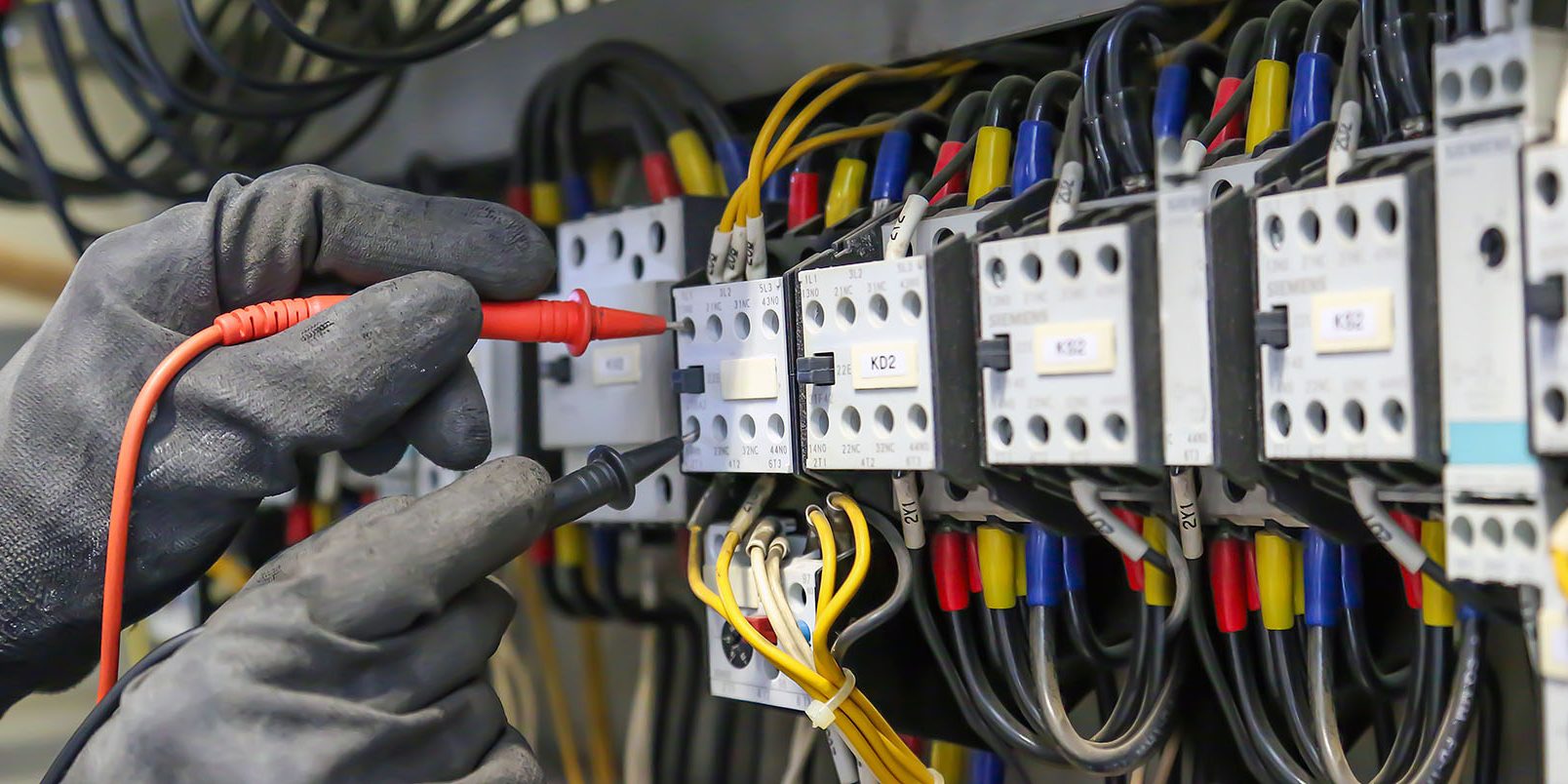 Electrical engineer using digital multi-meter measuring equipmen Electrical Service